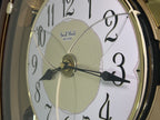 Rhythm "Woodgrain Stars" Moving Dial Magic Motion Musical Wall Clock - 4MH843WS23
