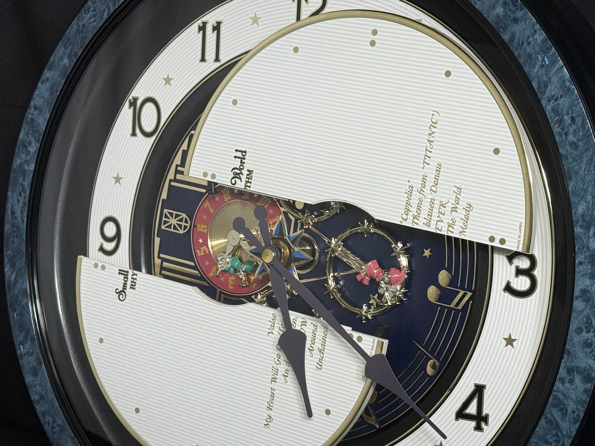 Rhythm “Small World Partage Home (Blue)” Moving Dial Magic Motion Musical Wall Clock with Popular Melodies - 4MH754RH04