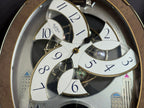Rhythm “Tri-Cracker” Moving Dial Magic Motion Musical Wall Clock with Popular Melodies - 4MH759NR06