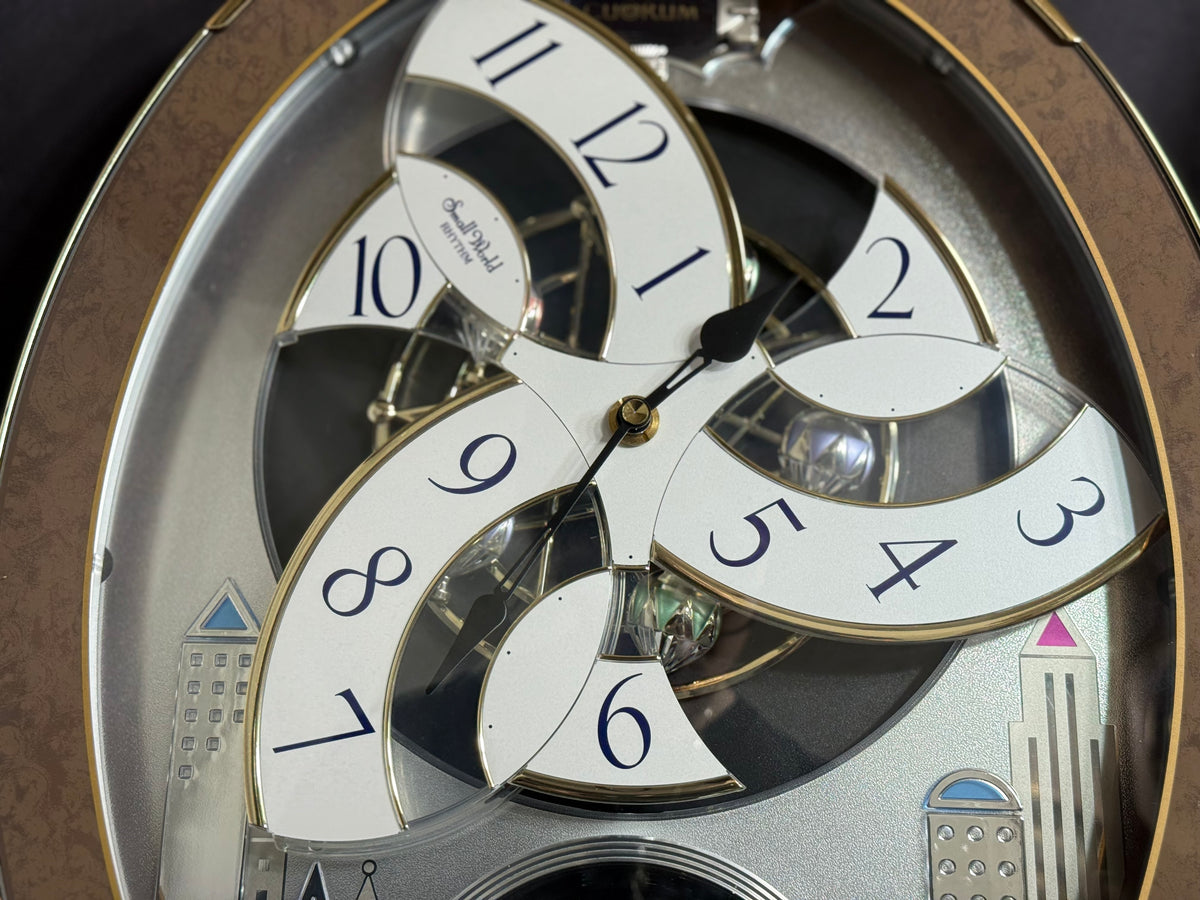 Rhythm “Tri-Cracker” Moving Dial Magic Motion Musical Wall Clock with Popular Melodies - 4MH759NR06