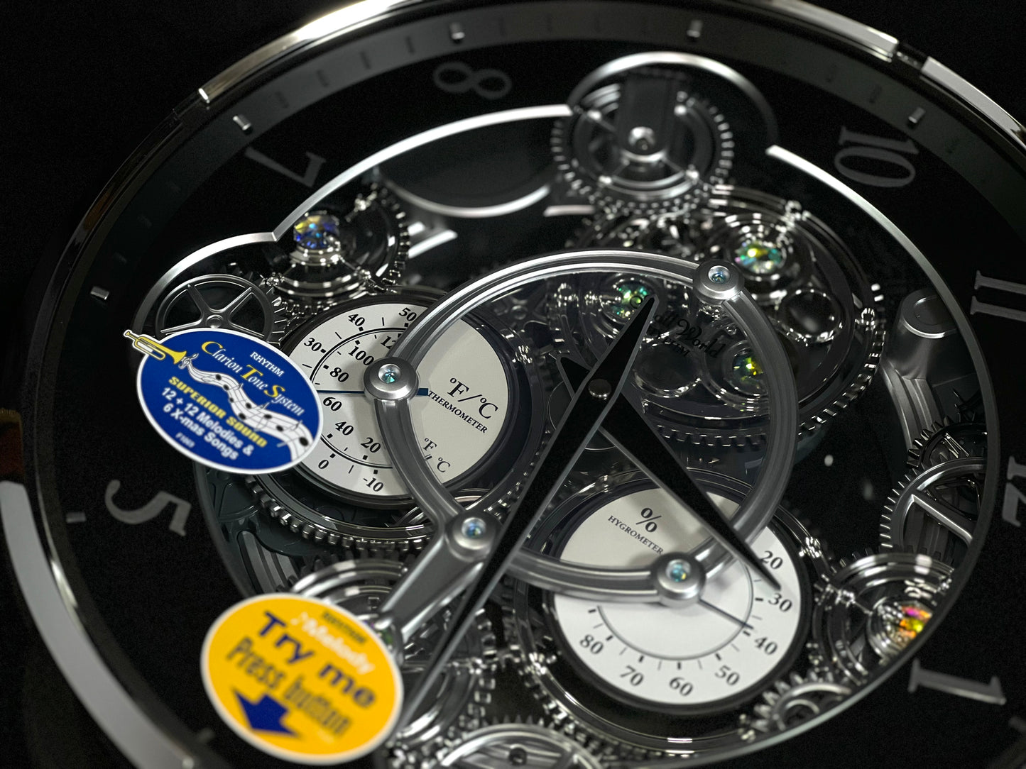 Rhythm “Chronograph (Black/Silver)” Skeletonized Dial Magic Motion Musical Wall Clock with Moving Gears - 4MH442WU08