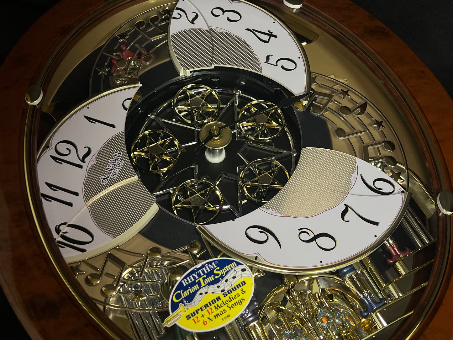 Rhythm "Woodgrain Stars" Moving Dial Magic Motion Musical Wall Clock - 4MH843WS23