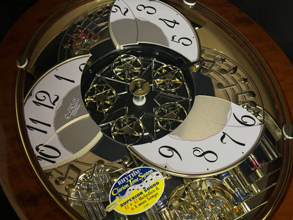 Rhythm "Woodgrain Stars" Moving Dial Magic Motion Musical Wall Clock - 4MH843WS23