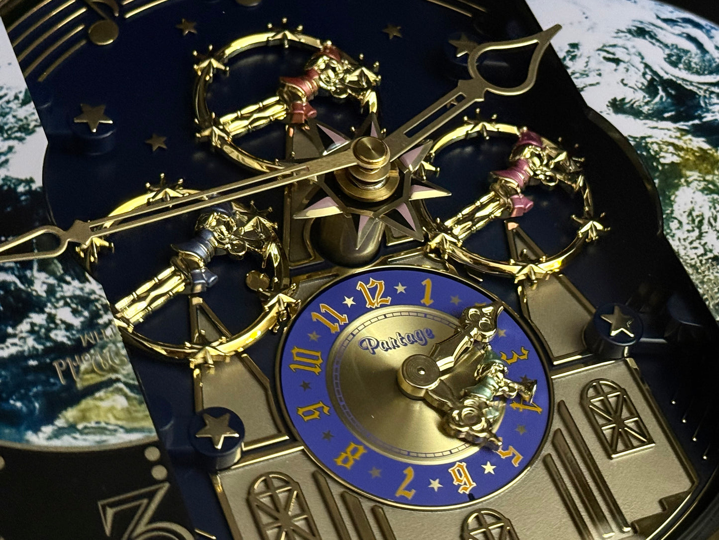 Rhythm “Peaceful Cosmos Entertainer” Moving Earth Dial Magic Motion Musical Wall Clock with Popular Melodies - 4MH839WB19