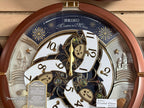 Seiko QXM378BRH “Castle Night” Melodies in Motion Dancing Dial Musical Wall Clock with 18 Songs