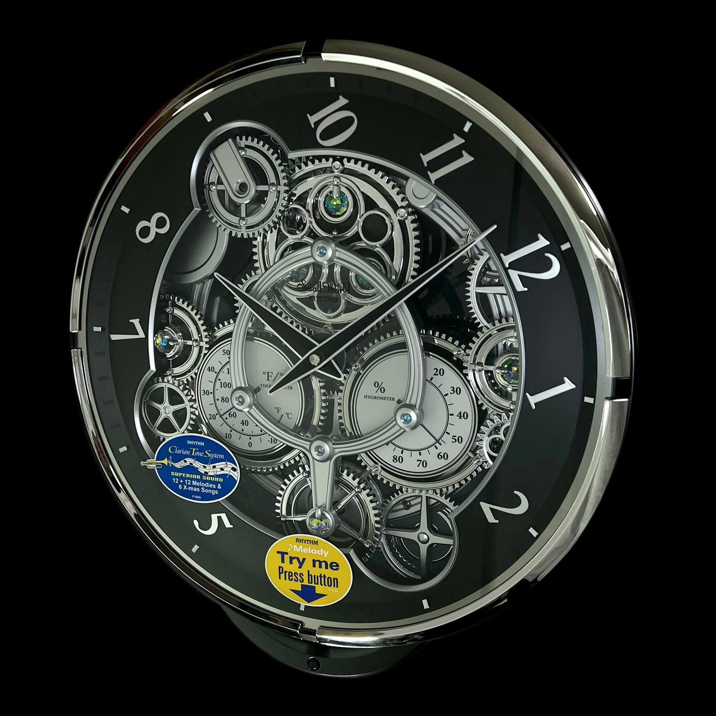 Rhythm “Chronograph (Black/Silver)” Skeletonized Dial Magic Motion Musical Wall Clock with Moving Gears - 4MH442WU08