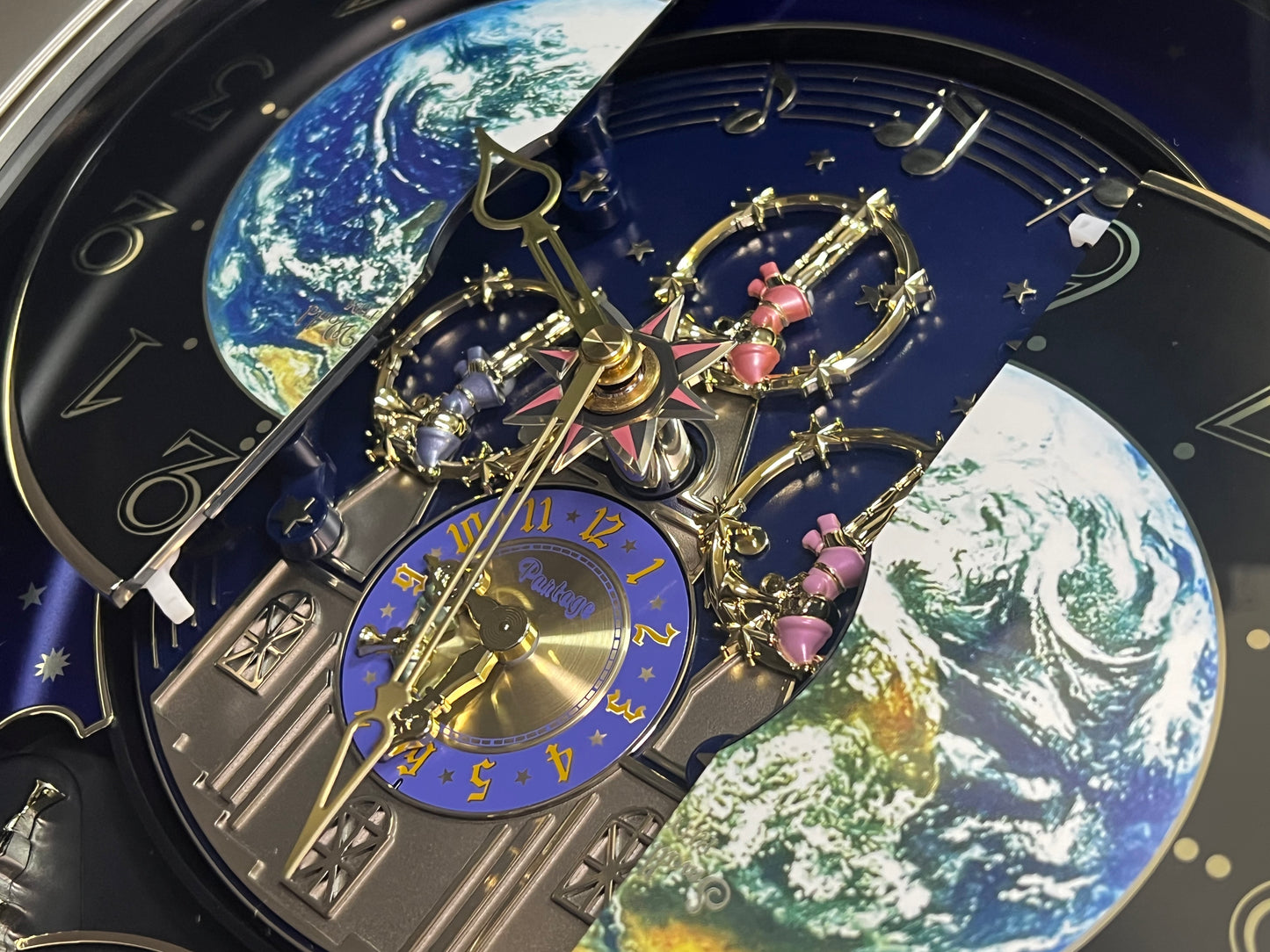 Rhythm “Peaceful Cosmos” Moving Earth Dial Magic Motion Musical Wall Clock with Popular Melodies - 4MH751AR19