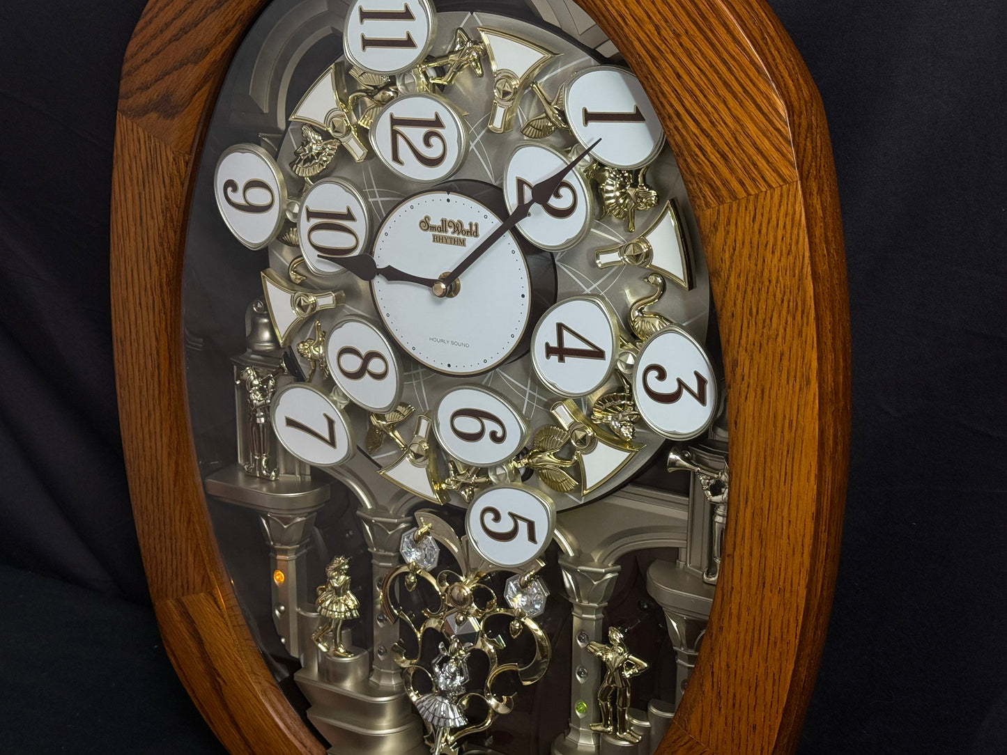 Rhythm "SSS Encore" Magic Motion Musical Wooden Wall Clock with Animated Moving Dial and Popular Melodies - 4MH810-R06