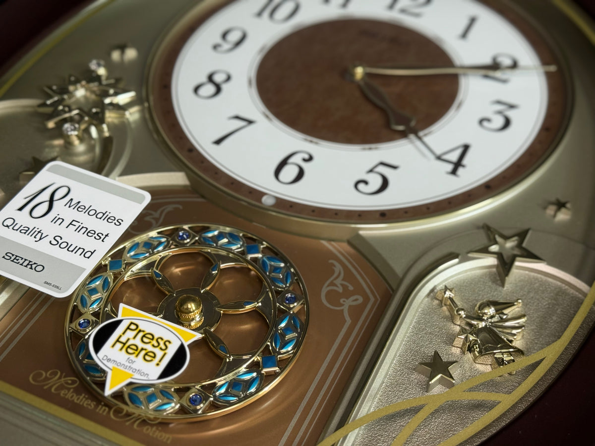 Seiko QXM357BRH “Warm Summer Stars” Melodies in Motion Musical Decorative Moving Wall Clock with 19 Songs