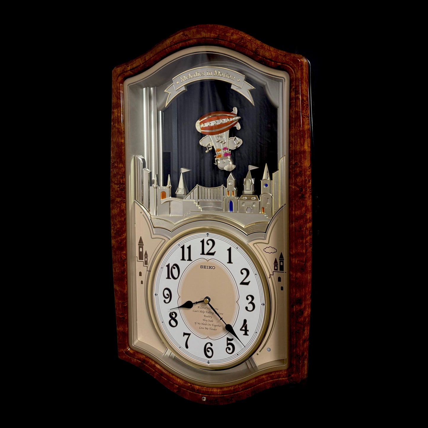 Seiko QXM135BRH "Lover’s Castle" Melodies in Motion Musical Moving Wall Clock with Popular Melodies