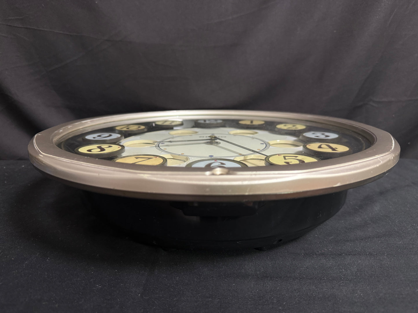 Seiko QXM106SRH "Twirling Numbers" Melodies in Motion Musical Wall Clock with Moving Dial