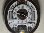 Seiko QXM615BRH “Snow Castle” Melodies in Motion Dancing Dial Musical Wall Clock with 40 Songs