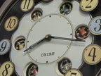 Seiko QXM106SRH "Twirling Numbers" Melodies in Motion Musical Wall Clock with Moving Dial