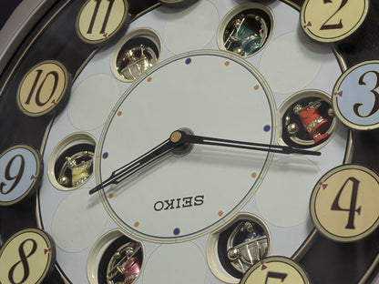 Seiko QXM106SRH "Twirling Numbers" Melodies in Motion Musical Wall Clock with Moving Dial