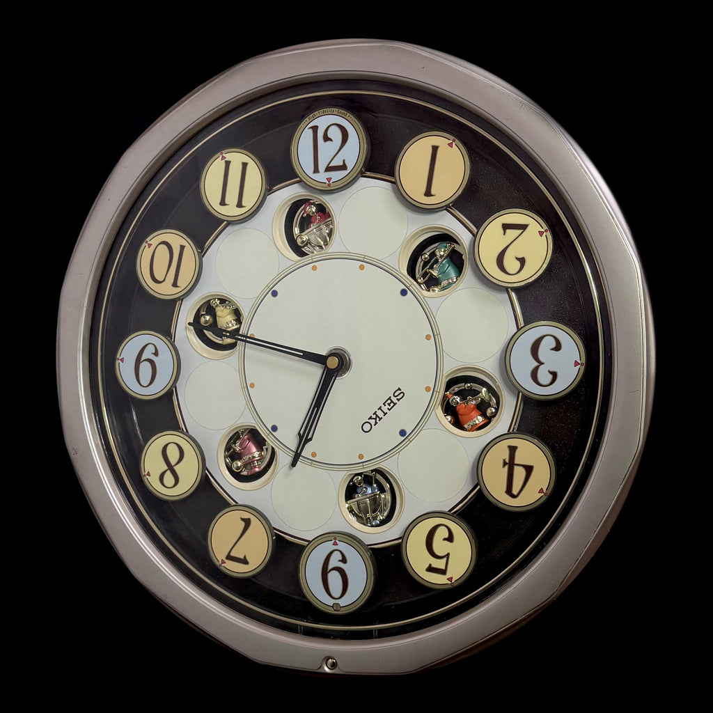 Seiko QXM106SRH "Twirling Numbers" Melodies in Motion Musical Wall Clock with Moving Dial