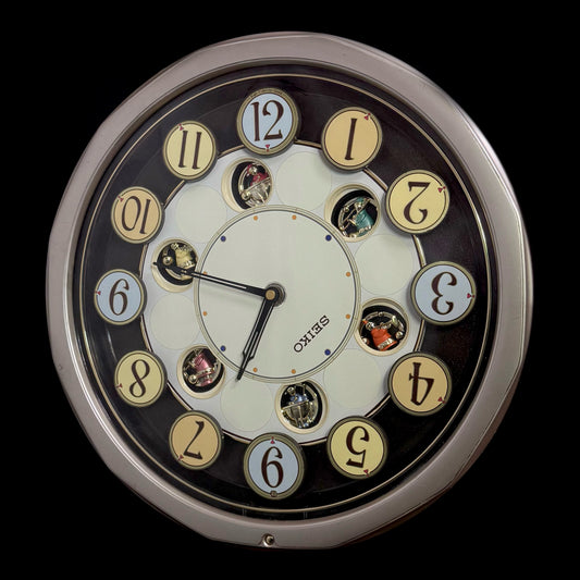 Seiko QXM106SRH "Twirling Numbers" Melodies in Motion Musical Wall Clock with Moving Dial