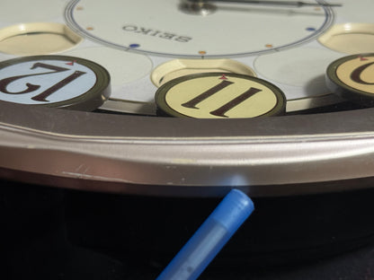 Seiko QXM106SRH "Twirling Numbers" Melodies in Motion Musical Wall Clock with Moving Dial