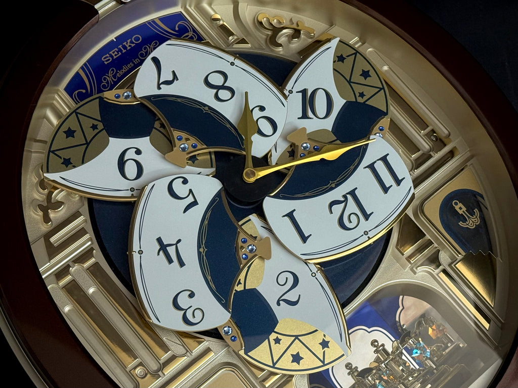Seiko QXM356BRH "Golden Pillars" Melodies in Motion Dancing Dial Musical Wall Clock with 18 Songs