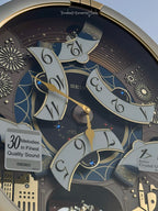 Seiko QXM620GRH "Golden Festival" Melodies in Motion Dancing Dial Musical Wall Clock with 30 Songs
