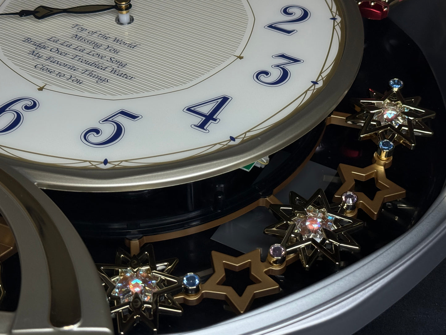 Seiko QXM155SRH "Twinkling Stars" Melodies in Motion Musical Decorative Pendulum Wall Clock with Popular Music