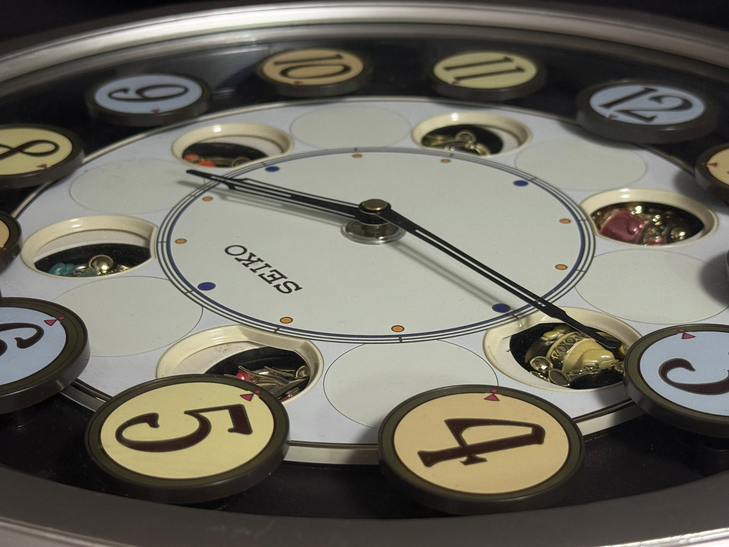 Seiko QXM106SRH "Twirling Numbers" Melodies in Motion Musical Wall Clock with Moving Dial