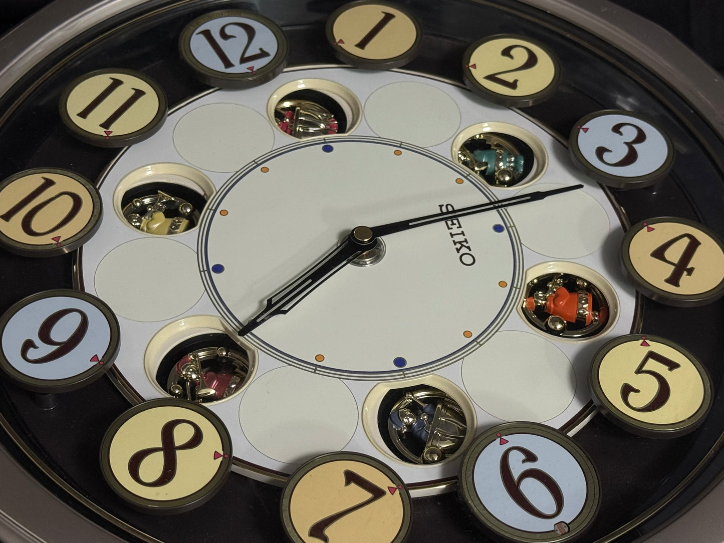 Seiko QXM106SRH "Twirling Numbers" Melodies in Motion Musical Wall Clock with Moving Dial