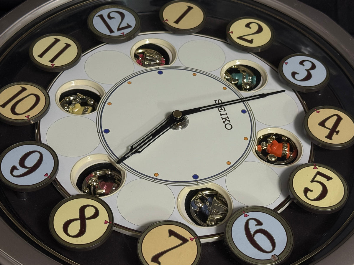 Seiko QXM106SRH "Twirling Numbers" Melodies in Motion Musical Wall Clock with Moving Dial