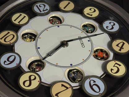 Seiko QXM106SRH "Twirling Numbers" Melodies in Motion Musical Wall Clock with Moving Dial