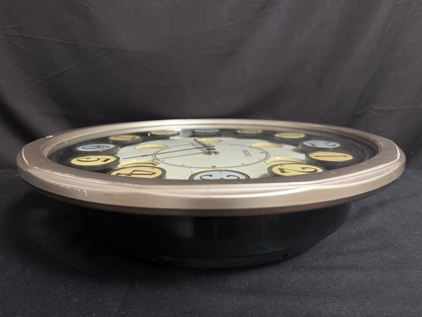 Seiko QXM106SRH "Twirling Numbers" Melodies in Motion Musical Wall Clock with Moving Dial