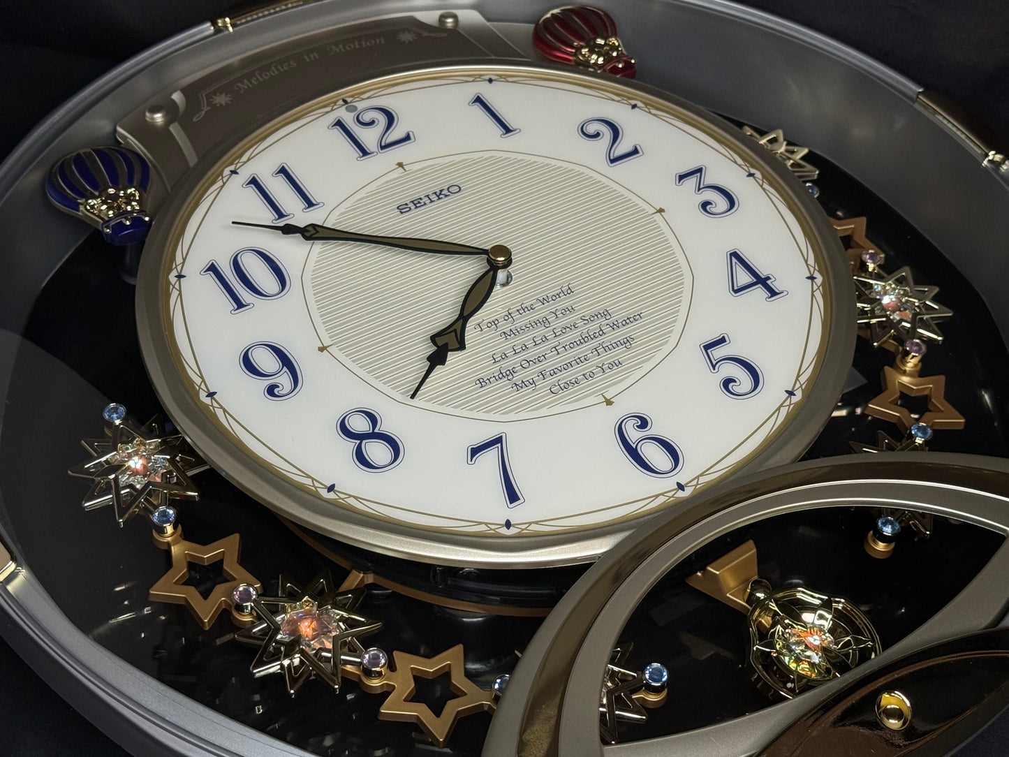 Seiko QXM155SRH "Twinkling Stars" Melodies in Motion Musical Decorative Pendulum Wall Clock with Popular Music