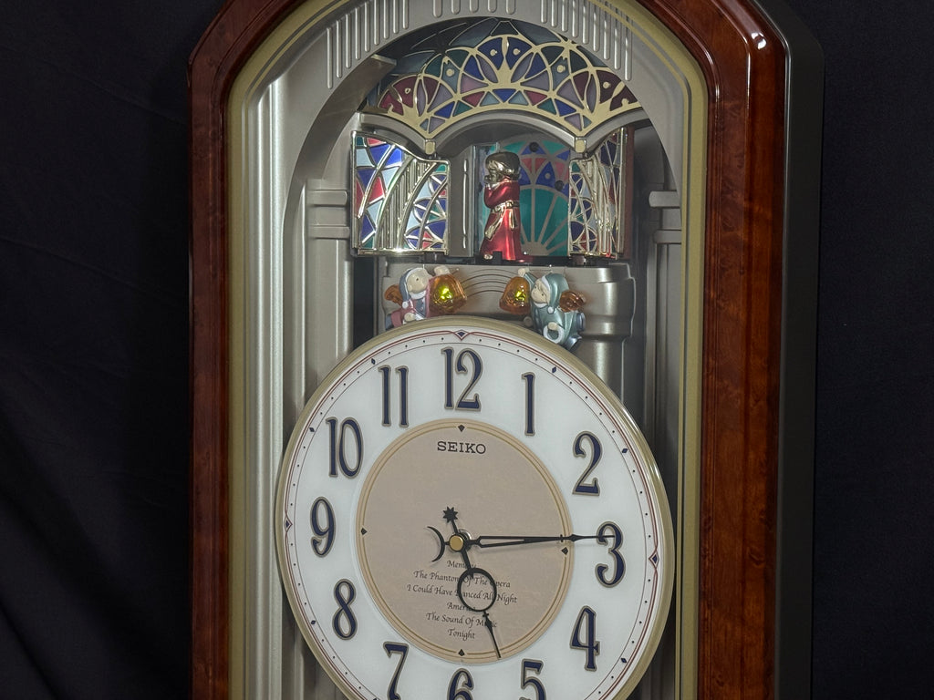 Seiko QXM123BRH "Broadway Showtunes Dropping Dial" Melodies in Motion Musical Moving Wall Clock with Popular Melodies