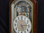 Seiko QXM123BRH "Broadway Showtunes Dropping Dial" Melodies in Motion Musical Moving Wall Clock with Popular Melodies