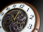 Seiko QXM380BRH “Mechanical” Melodies in Motion Dancing Dial Musical Wall Clock with 18 Songs