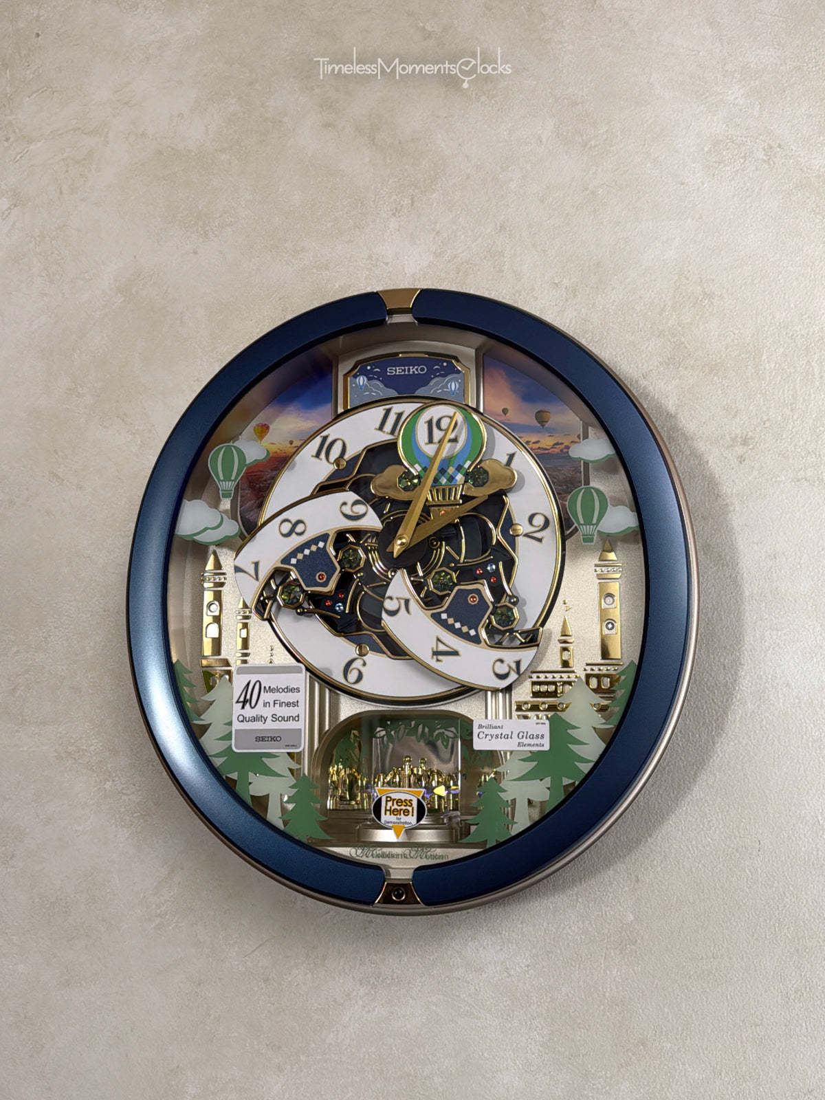 Seiko QXM398LRH “Blue Pine Fantasy” Melodies in Motion Dancing Dial Musical Wall Clock with 40 Songs