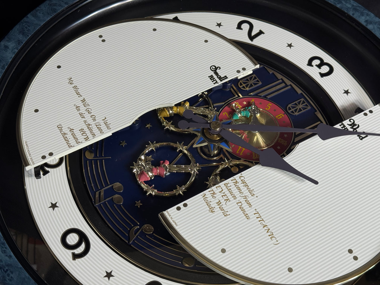 Rhythm “Small World Partage Home (Blue)” Moving Dial Magic Motion Musical Wall Clock with Popular Melodies - 4MH754RH04