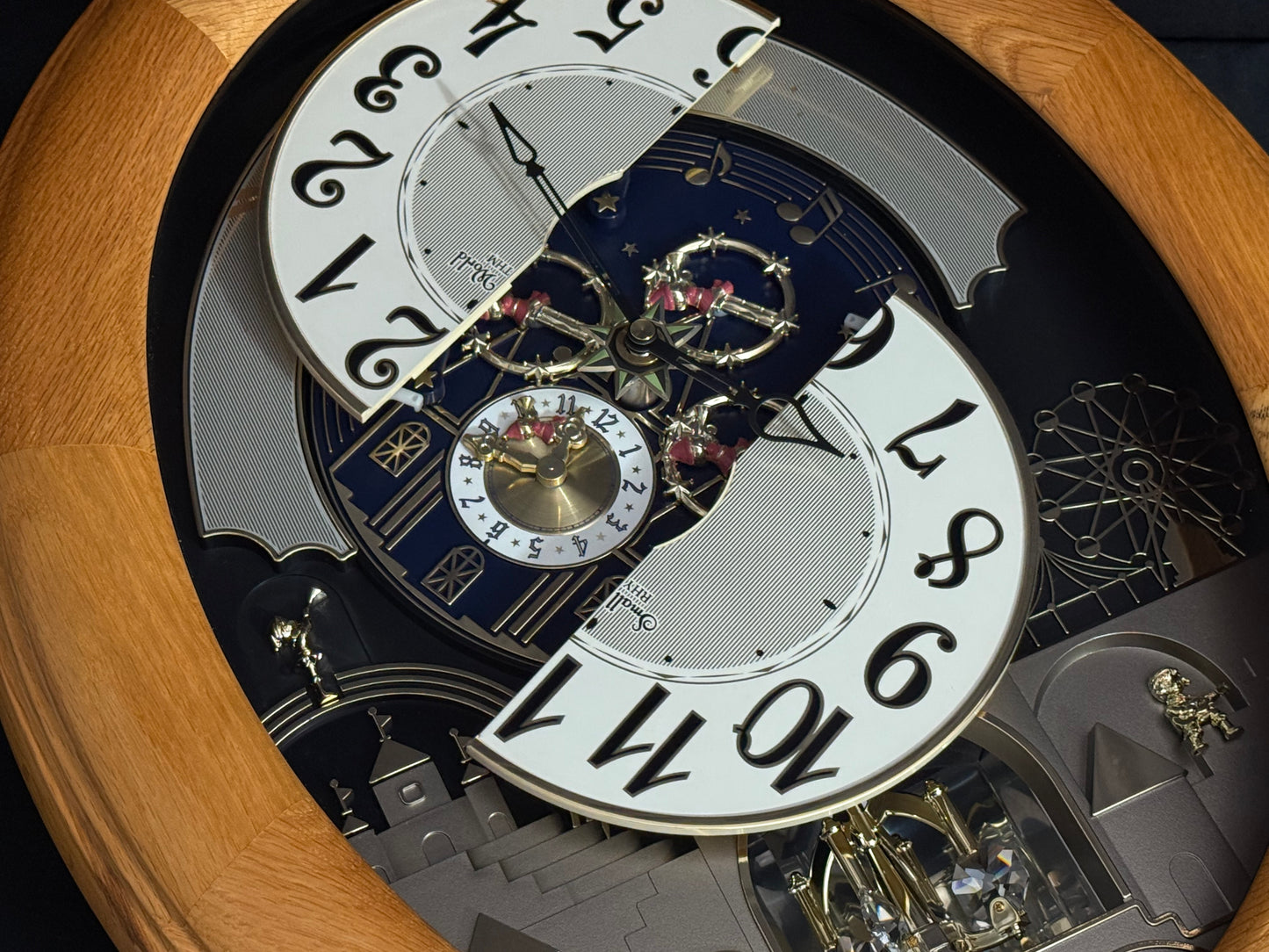 Rhythm "Timecracker Golden Oak" Moving Dial Magic Motion Musical Wooden Wall Clock with Popular Melodies - 4MH782-R07