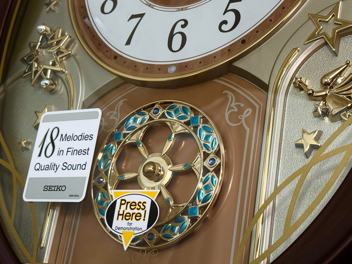 Seiko QXM357BRH “Warm Summer Stars” Melodies in Motion Musical Decorative Moving Wall Clock with 19 Songs