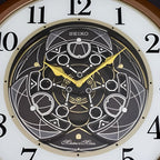Seiko QXM380BRH “Mechanical” Melodies in Motion Dancing Dial Musical Wall Clock with 18 Songs