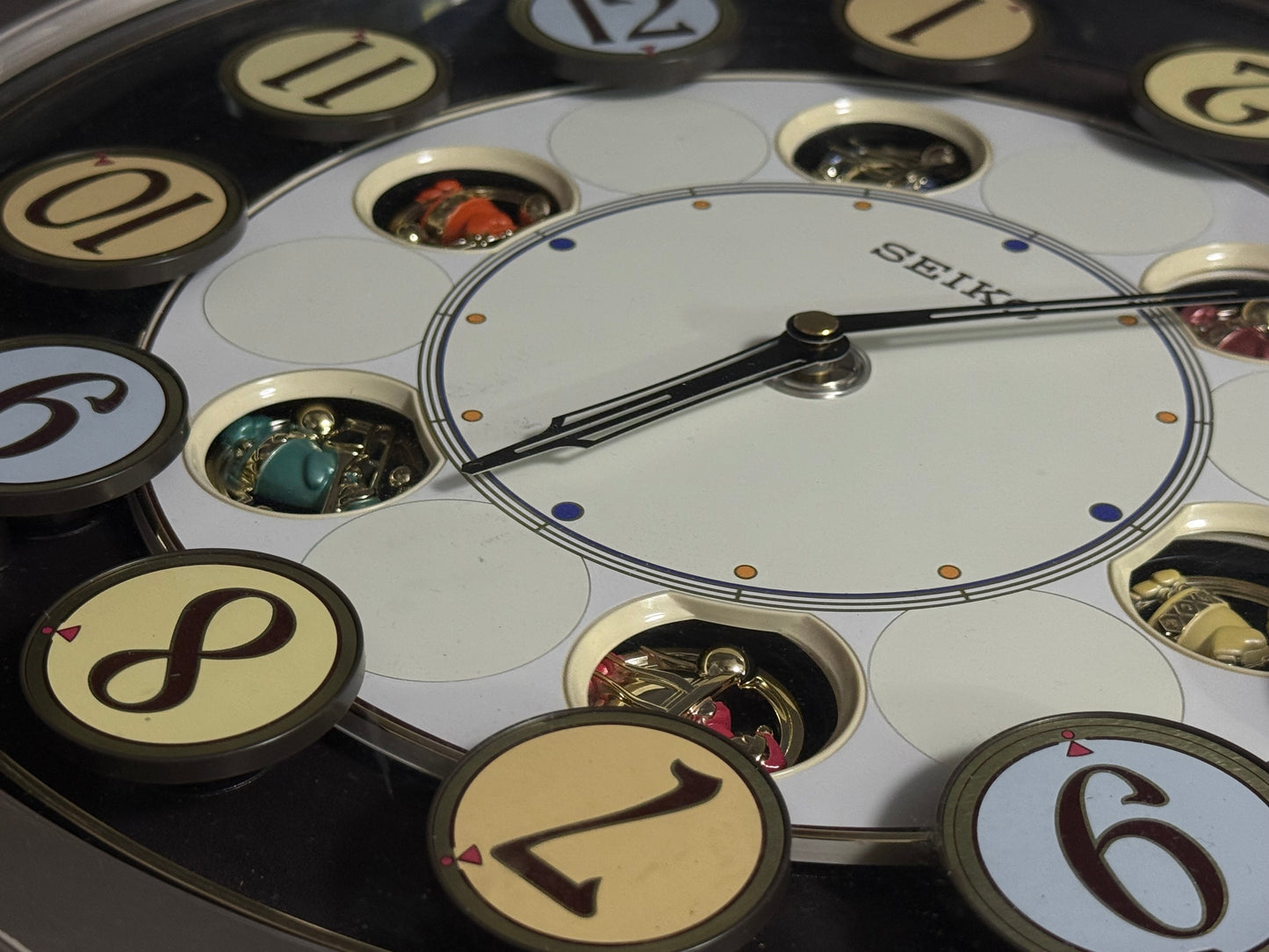 Seiko QXM106SRH "Twirling Numbers" Melodies in Motion Musical Wall Clock with Moving Dial