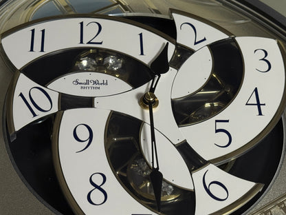 Rhythm "CTS Brilliance" Moving Dial Magic Motion Musical Wall Clock with Popular Melodies - 4MH787-R18