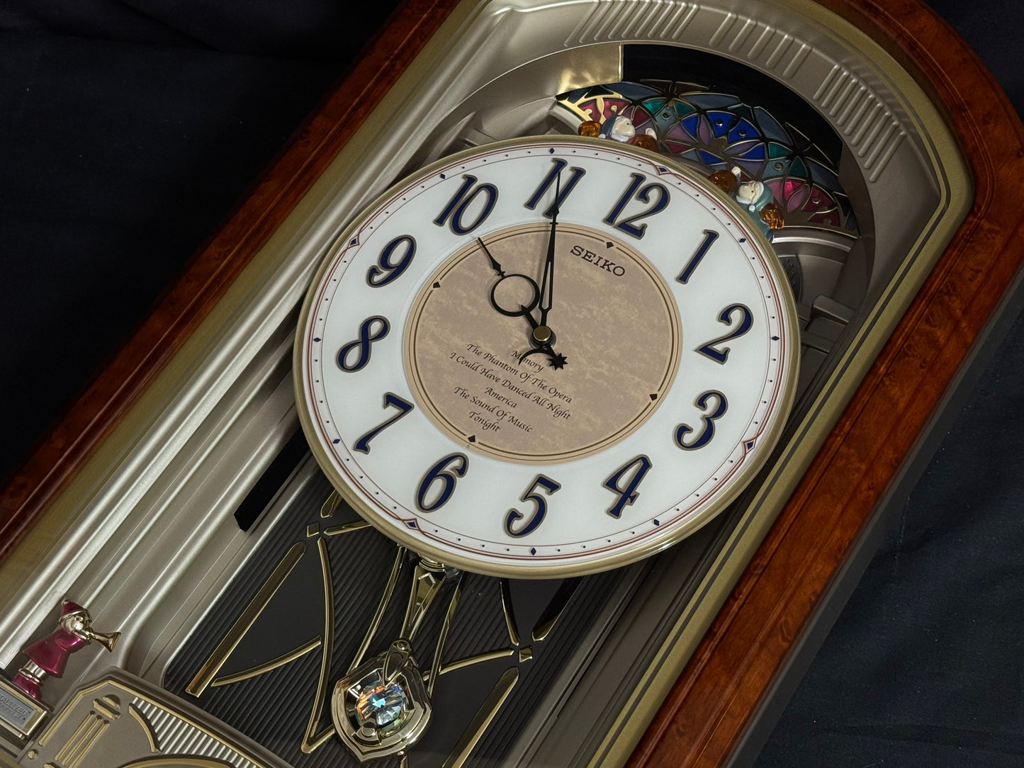 Seiko QXM123BRH "Broadway Showtunes Dropping Dial" Melodies in Motion Musical Moving Wall Clock with Popular Melodies