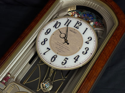 Seiko QXM123BRH "Broadway Showtunes Dropping Dial" Melodies in Motion Musical Moving Wall Clock with Popular Melodies