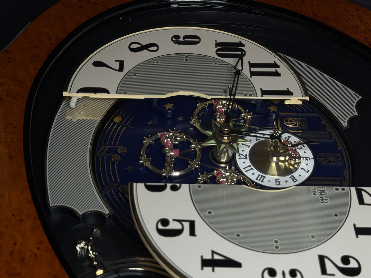 Rhythm “DWS Timecracker” Moving Dial Magic Motion Musical Wooden Wall Clock with Popular Melodies - 4MH752-R06