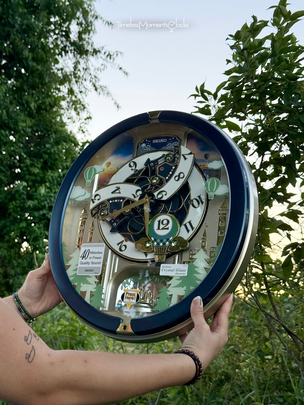 Seiko QXM398LRH “Blue Pine Fantasy” Melodies in Motion Dancing Dial Musical Wall Clock with 40 Songs