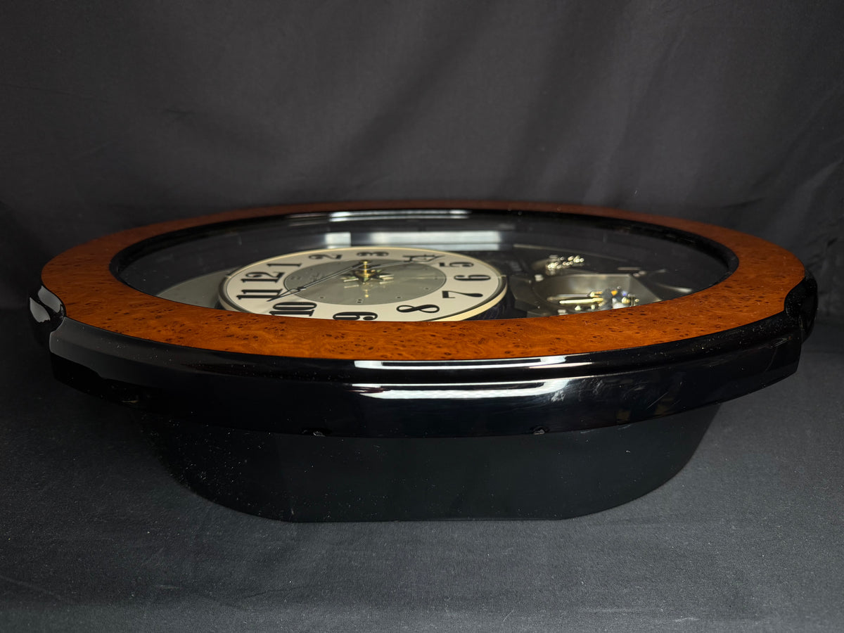 Rhythm “DWS Timecracker” Moving Dial Magic Motion Musical Wooden Wall Clock with Popular Melodies - 4MH752-R06