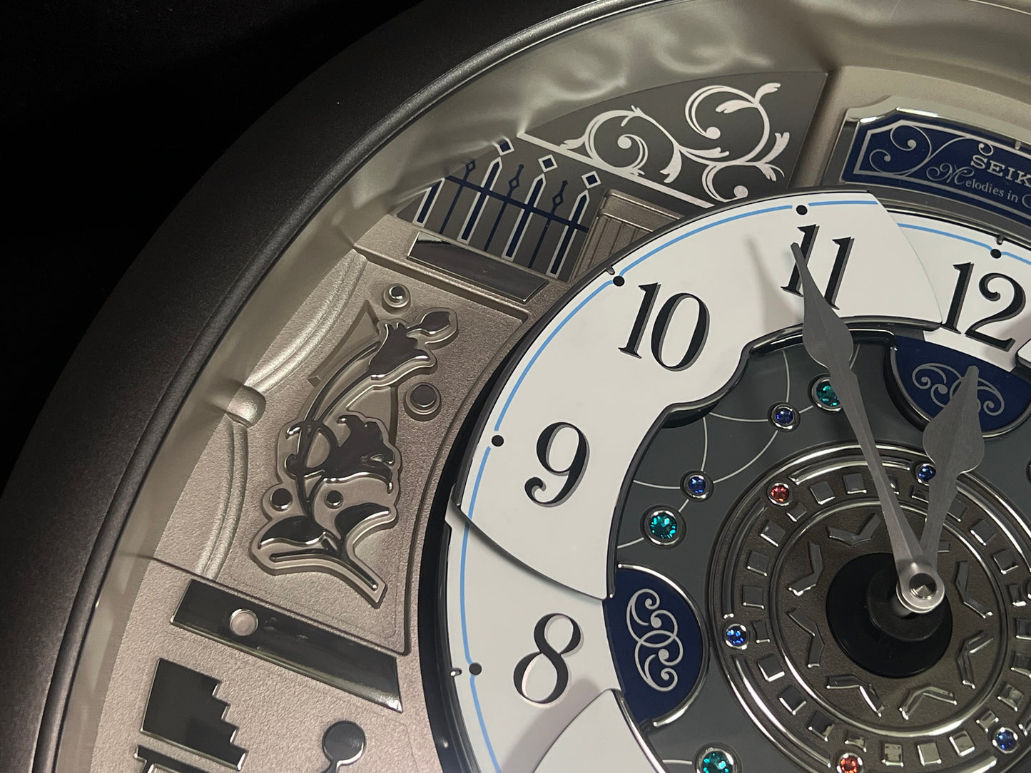 Seiko QXM366SRH “Musical Motifs” Melodies in Motion Dancing Dial Musical Wall Clock