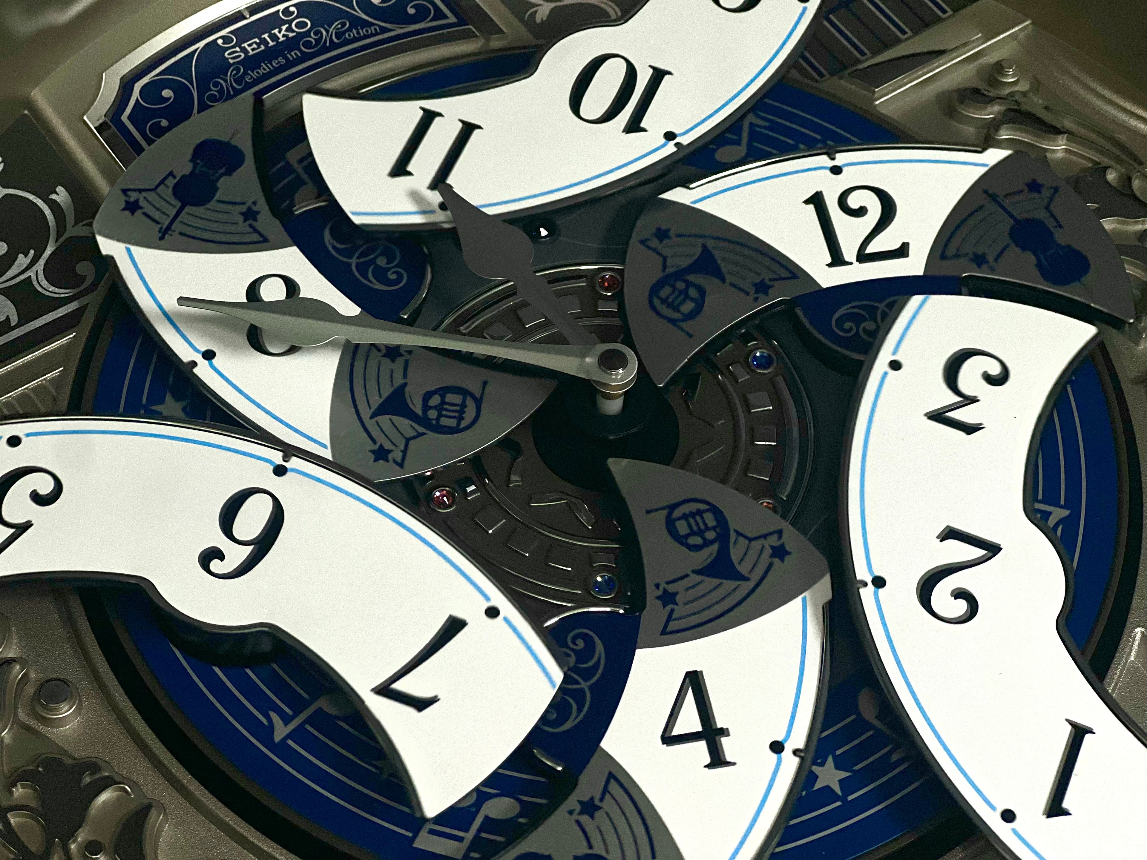 Seiko QXM366SRH “Musical Motifs” Melodies in Motion Dancing Dial Musical Wall Clock with 18 Songs