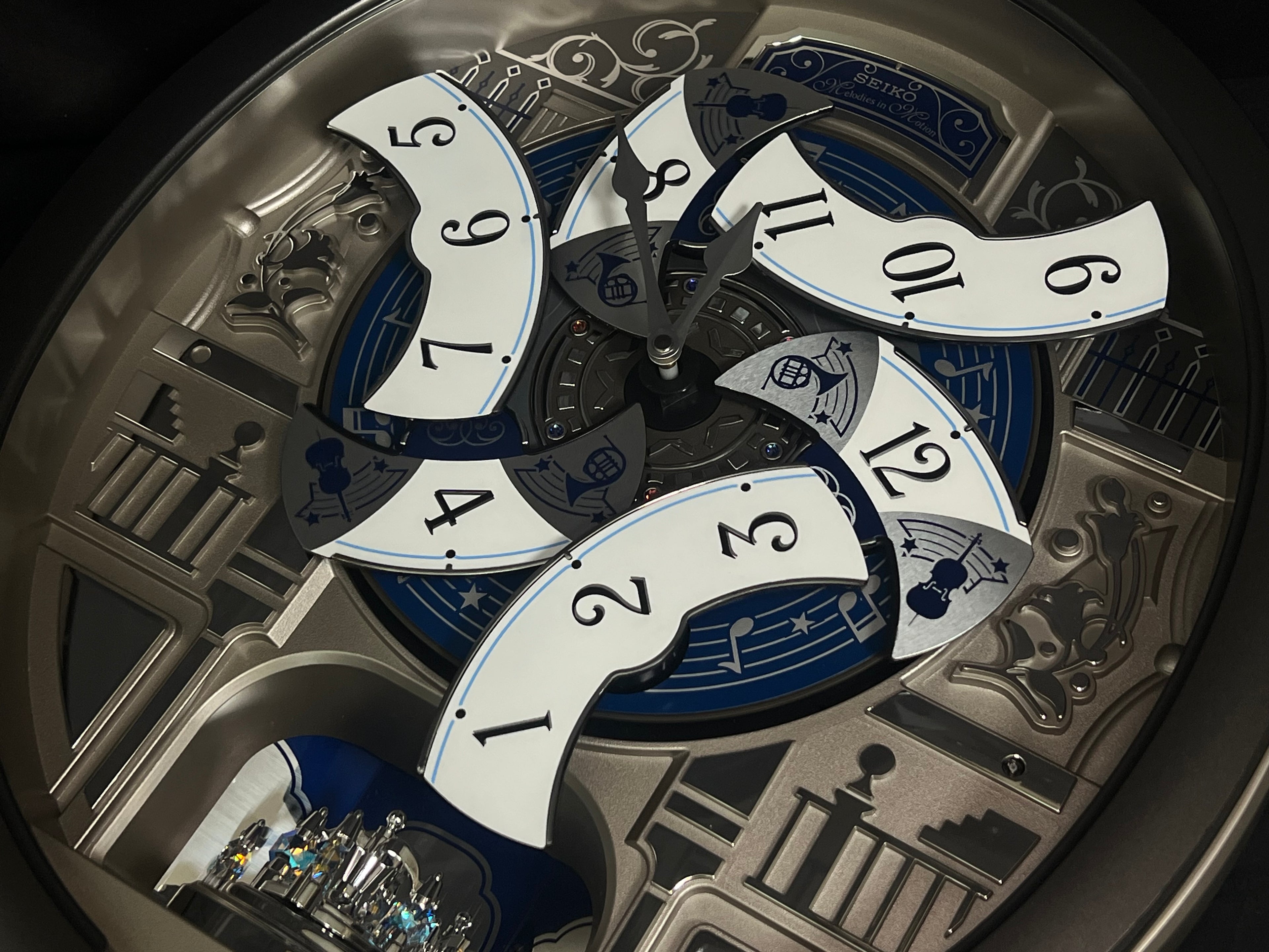 Seiko QXM366SRH “Musical Motifs” Melodies in Motion Dancing Dial Musical Wall Clock with 18 Songs