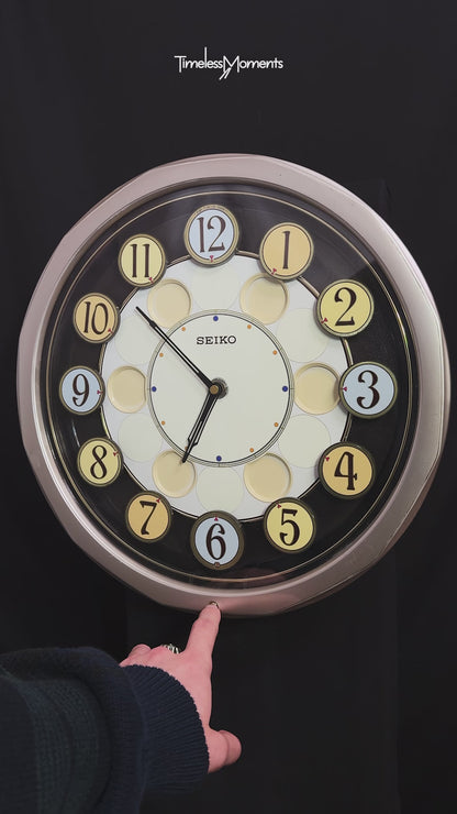 Seiko QXM106SRH "Twirling Numbers" Melodies in Motion Musical Wall Clock with Moving Dial