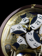 Seiko QXM356BRH "Golden Pillars" Melodies in Motion Dancing Dial Musical Wall Clock with 18 Songs